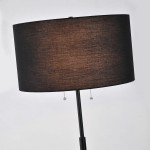 Lampa podłogowa Fogo 2xE27 w kolorze czarnym, z prostym, owalnym abażurem z tkaniny. Ustawiona w pionie, z dwoma szklanymi, wiszącymi przełącznikami. Idealna do nowoczesnych wnętrz, zapewniająca ciepłe oświetlenie.