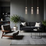 Lampa wisząca Ambiente 3xLED/18W w kolorze grafitowym z trzema cylindrycznymi kloszami, zawieszona na długich kablach. Produkt umieszczony w nowoczesnym wnętrzu z szaro-skalnym wystrojem, w pobliżu sofy i rośliny w donicy.