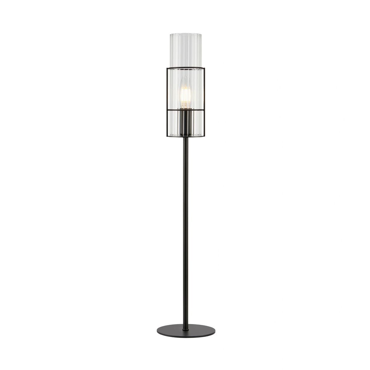 Czarna lampa stołowa Tubo H65 z przeźroczystym kloszem, z metalową podstawą i cylindrycznym kształtem. Ujęcie z boku, stojąca, z widoczną żarówką E14. Prosta, nowoczesna forma, idealna do wnętrz.