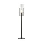 Czarna lampa stołowa Tubo H65 z przeźroczystym kloszem, z metalową podstawą i cylindrycznym kształtem. Ujęcie z boku, stojąca, z widoczną żarówką E14. Prosta, nowoczesna forma, idealna do wnętrz.