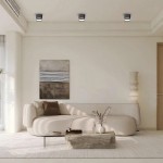 Czarna lampa sufitowa Kendal 1xGX53, zamontowana na suficie, emitująca jasne światło. W tle nowoczesny salon z jasnymi ścianami, sofą w odcieniu beżu i drewnianą ławą. Obrazy i dekoracje w minimalistycznym stylu.