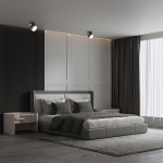 Czarna lampa sufitowa Kendal (spot) 1xGX53, zamontowana na suficie, o regulowanym kącie świecenia. W tle elegancka sypialnia z łóżkiem, szafką nocną i zasłonami, co tworzy nowoczesny klimat.
