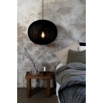 Lampa wisząca Florence D50 w kolorze czarnym z kloszem w kształcie okrągłym, zawieszona nad drewnianym stolikiem. Wnętrze w stylu industrialnym z widoczną fakturą ściany. Widoczna żarówka E27 wewnątrz lampy.