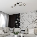 Lampa sufitowa Vibra 4xE14 w kolorze czarnym i grafitowym, z czterema okrągłymi kloszami, zamontowana na suficie. Ujęcie z dołu, w aranżacji nowoczesnego wnętrza z jasnymi sofami i dekoracyjną ścianą.