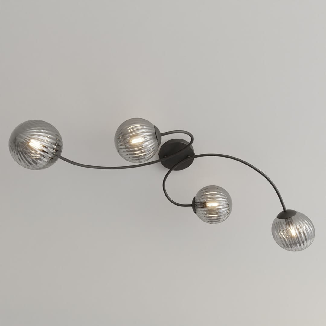 Lampa sufitowa Vibra 4xE14 w kolorze czarnym i grafitowym, z czterema szklanymi, okrągłymi kloszami w delikatne żłobienia. Ułożona na suficie, z elastycznymi ramionami, które nadają jej nowoczesny kształt.