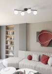 Czarna lampa sufitowa Opus z czterema opalowymi abażurami w kształcie kul. Produkt zamontowany na suficie, z lekko zakrzywionymi ramionami. W tle widoczny nowoczesny salon z jasną sofą i regałem.