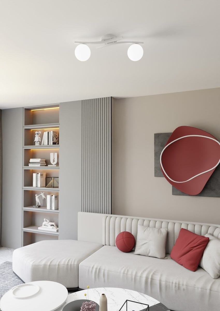 Lampa sufitowa Opus w białym kolorze z dwoma opalowymi kloszami, zamontowana na suficie. Klosze mają okrągły kształt, a całość utrzymana jest w minimalistycznym stylu. Tło przedstawia nowoczesny salon z jasną sofą i regałem.