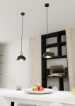 Lampa wisząca Seco 1xE27 w kolorze czarnym z jasnym drewnem, umieszczona na długich linkach. Wnętrze klosza jest białe, lampa zawieszona nad białym stołem, w tle jasna ściana z drewnianymi panelami i czarnymi regałami. Widoczne jabłka na stole.