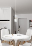 Lampa wisząca Target 1xE27 w kolorze białym z złotym detalem, zawieszona na cienkim przewodzie, umieszczona nad okrągłym białym stołem. W tle widoczne białe meble kuchenne i drzwi do pomieszczenia.