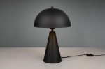 Czarna lampa stołowa Alfie z jedną oprawą E27, o cylindrycznym, stożkowatym kształcie. Górna część ma formę półkuli, a podstawa jest matowa. Produkt leży na białym stole, z widocznym kablem z włącznikiem.