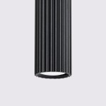 Lampa wisząca Karbon 2 w kolorze czarnym z dwoma gniazdami GU10. Posiada cylindryczny kształt z wyraźnym, poziomym żłobieniem. Widać dolną część lampy z białym kloszem, na prostym, jasnym tle.