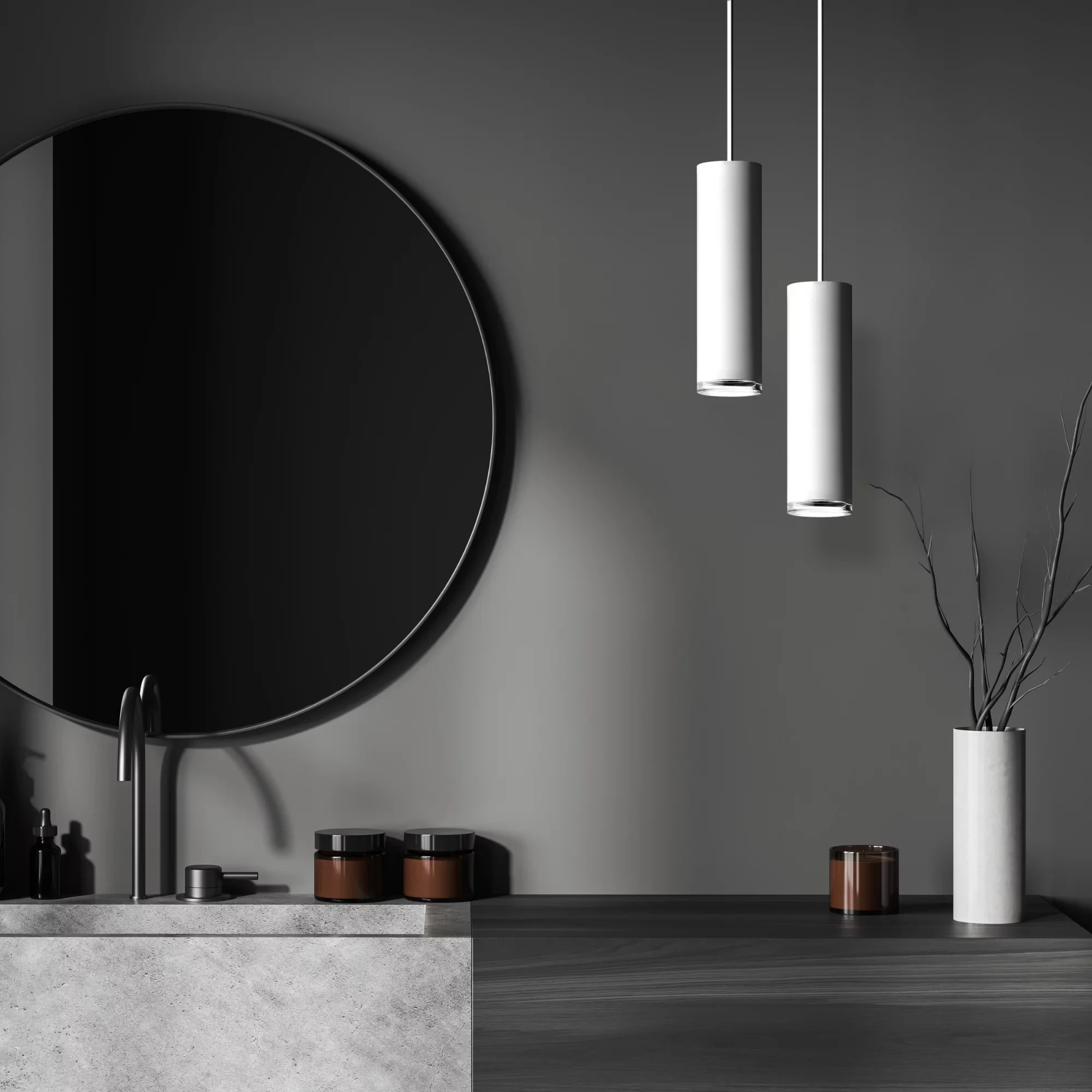 Lampa wisząca Turyn IP44 w kolorze białym, z cylindrycznym kształtem, zawieszona na cienkich przewodach. W tle widoczna okrągła lustro oraz stół z szarym blatem. Na stole brązowe pojemniki oraz wazon z gałązkami.