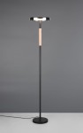 Lampa podłogowa Celeste z czarnym metalowym stelażem i przydymionym kloszem, z drewnianym uchwytem. Ujęcie frontalne, stojąca na płaskiej powierzchni. Widoczny kabel zasilający. Wymiary i detale konstrukcyjne nieokreślone.