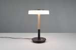 Lampa stołowa Celeste z białym kloszem i kawowym, okrągłym podstawą. Metalowa noga w odcieniu złotym. Ujęcie frontalne, stojąca na stole z widocznym kablem. Prosty, nowoczesny design. Idealna do biura lub sypialni.