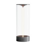 Lampa stołowa Esterno w kolorze szarym z przezroczystym kloszem. Wyposażona w 1xLED o mocy 1,2W, z funkcją IP44. Produkt stoi na okrągłej podstawie z przyciskiem włączania, ukazujący minimalistyczny design.