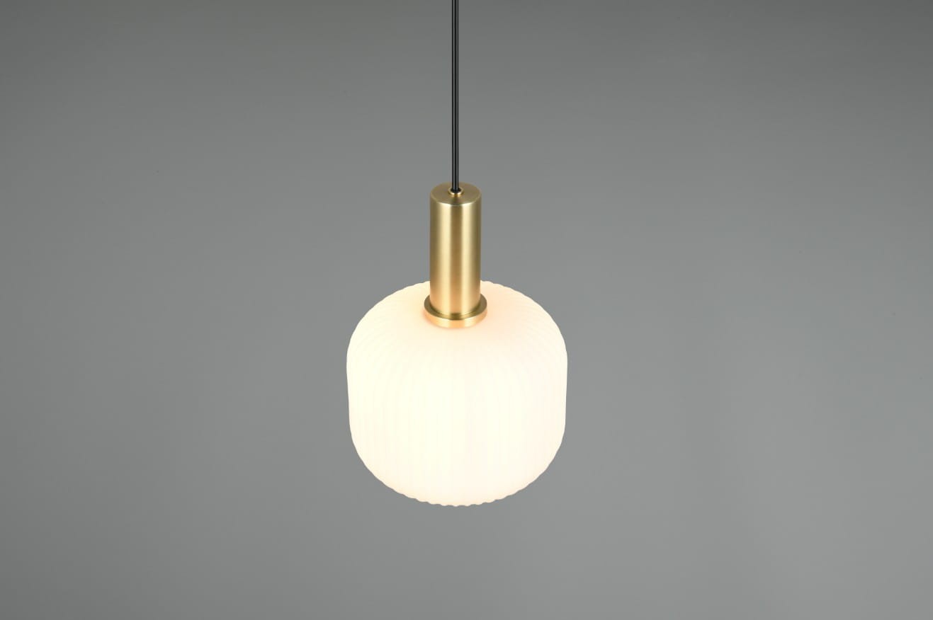 Lampa wisząca Diva w kolorze białym z metalowym uchwytem w odcieniu złotym. Okrągły klosz o fakturze falistej, zawieszony na cienkim, czarnym przewodzie. Produkt widoczny w górnej części kadru na szarym tle.