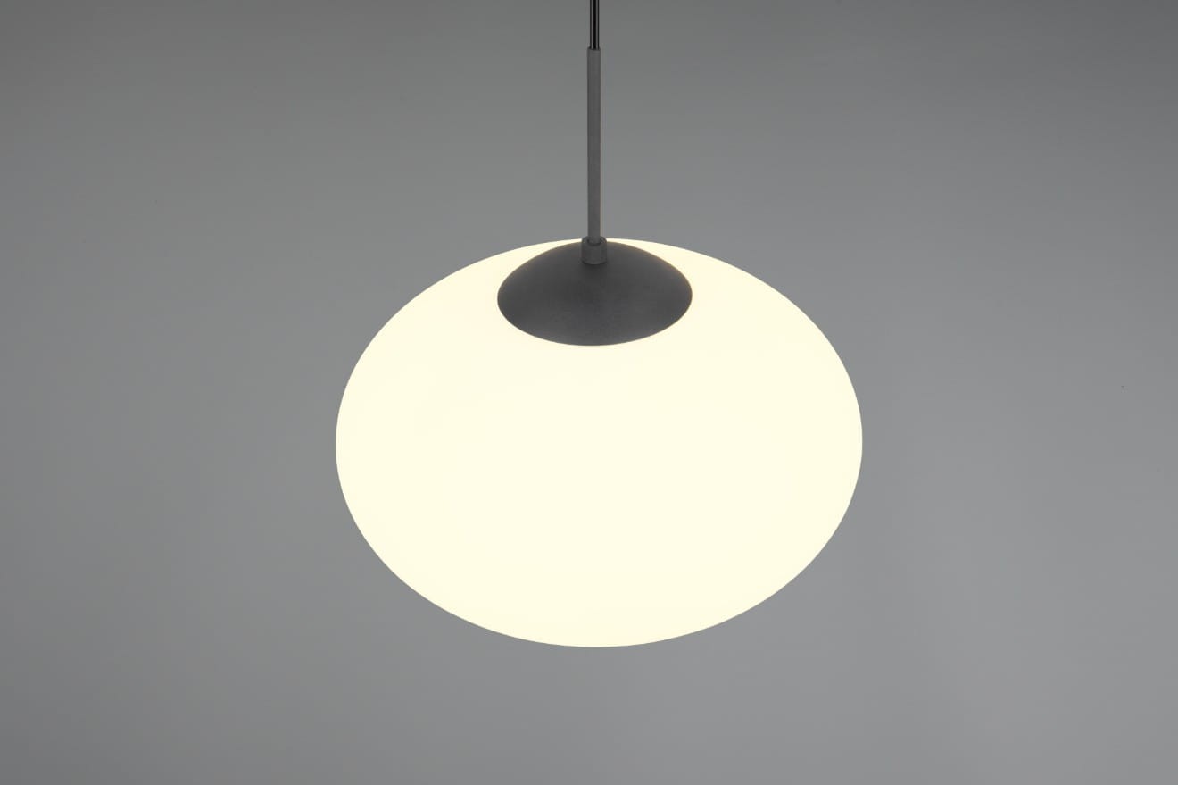 Lampa wisząca Fomento D40 z mocowaniem w kolorze czarnym, okrągła, z białym kloszem. Zawieszona na cienkim przewodzie, widoczny czarny detal u góry. Idealna do nowoczesnych wnętrz.
