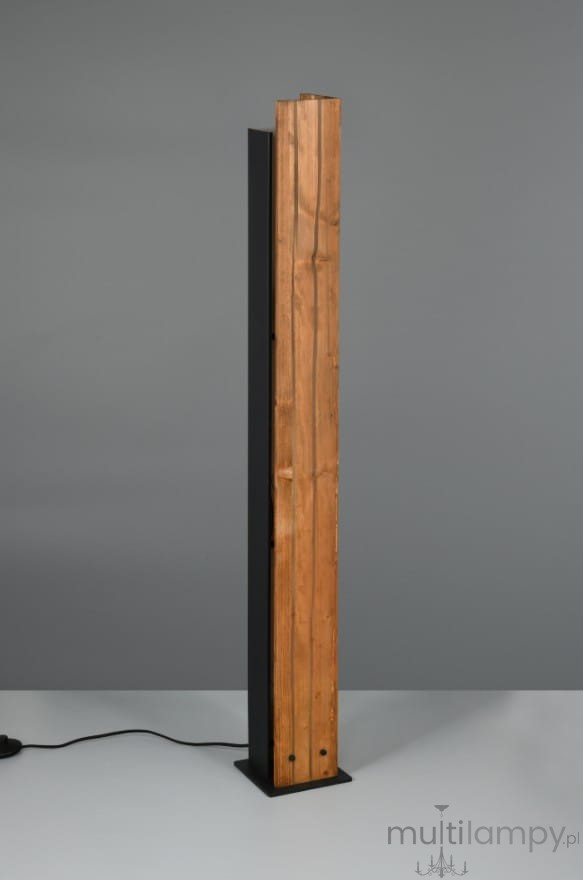 Lampa podłogowa Karuni z pojedynczym gniazdem E27, w kolorze czarnym z jasnym drewnem. Stojąca, prostokątna konstrukcja z widoczną teksturą drewna i czarną metalową podstawą. Kabel zasilający widoczny z boku.