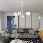 Lampa wisząca Idea 4-punktowa w kolorze białym z minimalistycznymi kloszami, zawieszona na długich linkach. Umieszczona nad szarej sofie w nowoczesnym wnętrzu z obrazem na ścianie i okrągłym stolikiem.