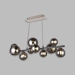 Lampa wisząca Sevilla z dziesięcioma źródłami światła G9, w kolorze czarnym i chromowanym. Posiada dymione, okrągłe klosze zawieszone na metalowej rurze, wiszącej na cienkich linkach, z prostokątnym wspornikiem sufitowym w jasnym kolorze.