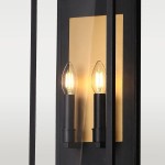 Kinkiet elewacyjny Malibu w kolorze czarnym i mosiądzu, z dwoma oprawkami E14. Produkt ma prostokątną, minimalistyczną formę z przezroczystymi kloszami w kształcie łezki, umieszczonymi obok złotej tła. Zainstalowany na ścianie.