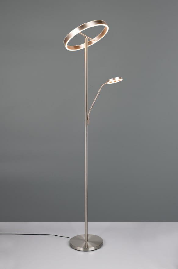 Lampa podłogowa Willis z niklowanym wykończeniem, z dwoma źródłami światła LED. Główna część w formie okręgu, a dodatkowe światło w elastycznej oprawie. Stojąca na okrągłej podstawie, kabel widoczny na podłodze. Tło szare.