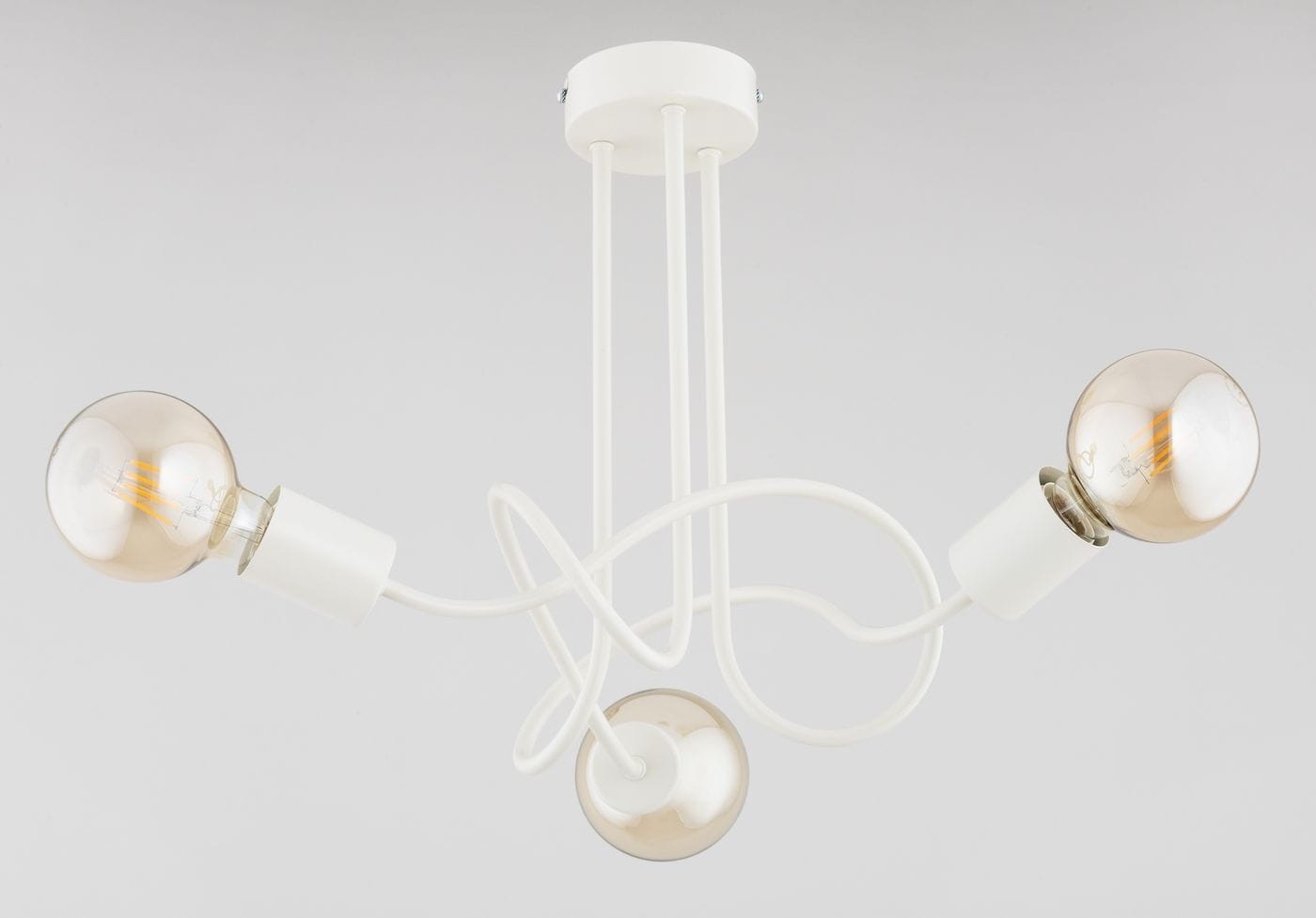 Lampa sufitowa Wingo Cream z trzema źródłami światła E27. Konstrukcja w kolorze kremowym, z widocznymi, okrągłymi kloszami w odcieniu brązowym. Ułożona w sposób asymetryczny, z delikatnymi, zakrzywionymi przewodami. Tło szare, neutralne.