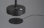 Czarna lampa stołowa Moreno z jednym źródłem LED 3W, z okrągłą podstawą i cienkim ramieniem. Widoczny przycisk zasilania na podstawie oraz kabel zasilający. Ujęcie z boku, na jednolitym tle.