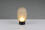 Lampa stołowa Facette z kloszem w kształcie owalnym, pokrytym teksturą, w kolorze kremowym. Podstawa czarna, z widocznym przyciskiem. Oświetlenie LED o mocy 1,5W. Ujęcie frontalne na białym tle.