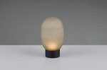Lampa stołowa Facette w kolorze czarnym i zielonym z podstawką z metalu. Owalny klosz z teksturowanego szkła w ciepłym odcieniu, emitujący światło LED o mocy 1,5W. Ujęcie frontalne na białym tle, lampa stoi na równym podłożu.
