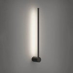 Kinkiet Catrina 60 w kolorze czarnym, z jedną diodą LED o mocy 9W i temperaturze barwowej 4000K. Produkt ma smukły, pionowy kształt z okrągłą podstawą, emitujący światło w górę na tle szarej ściany.