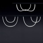 Wężyk LED 150 do szyny magnetycznej, oświetlenie w kolorze ciepłej bieli (4000K), z elastycznym kształtem, umieszczony na ciemnym tle. Widoczne różne ułożenia wężyków, tworzące dynamiczne linie. Idealny do nowoczesnych aranżacji.