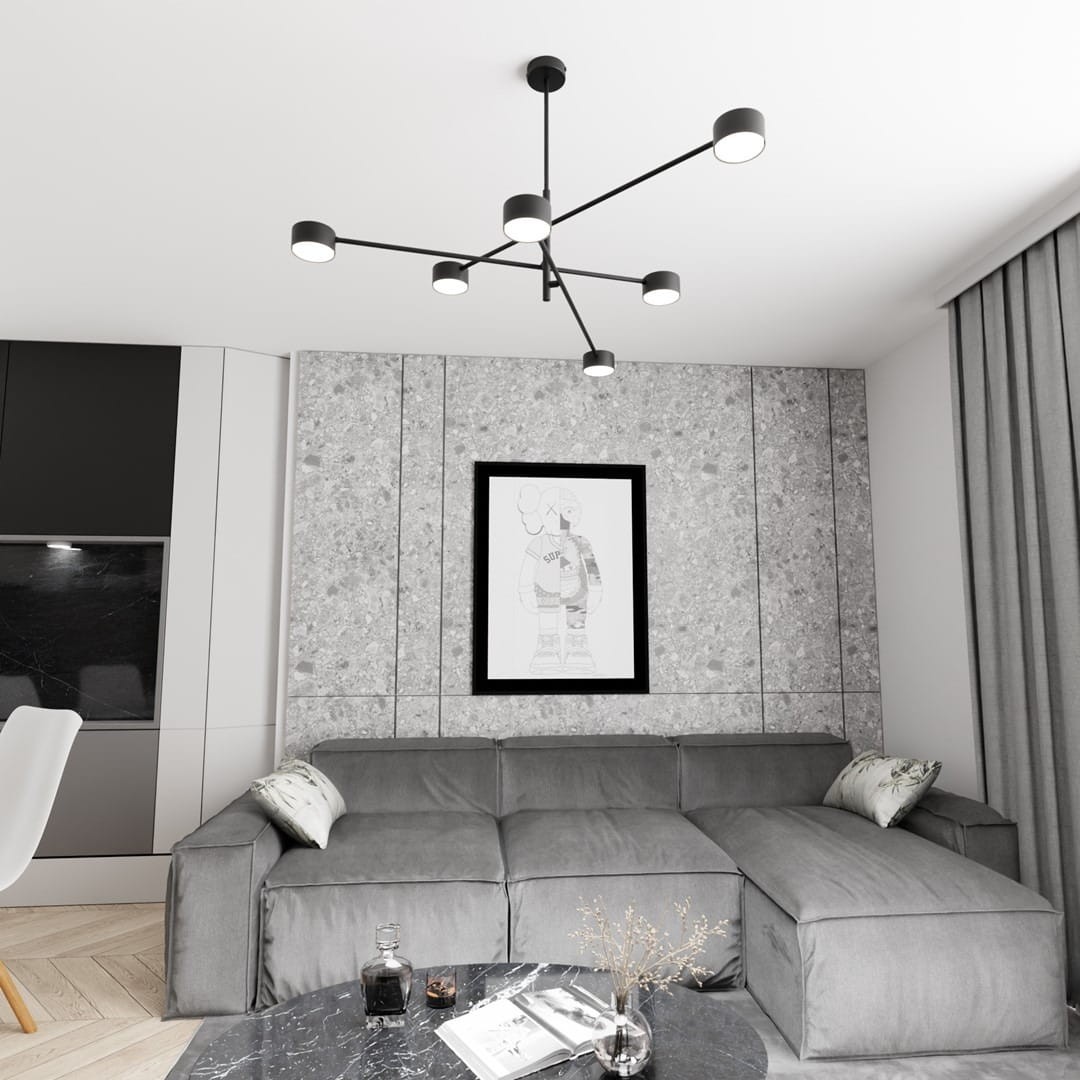 Lampa sufitowa Natsu w kolorze czarnym z sześcioma punktami świetlnymi GX53. Ułożona na suficie z minimalistycznym designem, w nowoczesnym wnętrzu z szaro-białą ścianą i sofą w kolorze szarym.