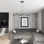 Lampa wisząca Sora w kolorze czarnym, z sześcioma oprawami GX53, zawieszona nad szarym narożnikiem w nowoczesnym wnętrzu. Ujęcie z dołu, z widocznym tle w postaci szarej ściany i dekoracyjnego obrazu.