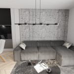 Lampa wisząca Sora w kolorze czarnym z sześcioma źródłami światła GX53. Zawieszona nad szarym narożnikiem w nowoczesnym wnętrzu, z betonową ścianą w tle. Prosty, minimalistyczny design, idealna do oświetlenia przestrzeni.