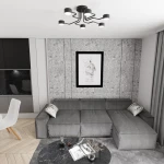 Lampa sufitowa Kurage w kolorze czarnym, z sześcioma źródłami światła GX53. Posiada nowoczesny, minimalistyczny kształt z wygiętymi ramionami, zamontowana na białym suficie, nad szaro-beżową kanapą w stylowym wnętrzu.