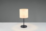 Lampa stołowa Aimee z czarną podstawą i naturalnym, teksturowanym kloszem w kształcie walca. Ujęcie frontalne, stojąca na białym blacie, z jasnym światłem emitowanym przez klosz. Tło szare, minimalistyczne.