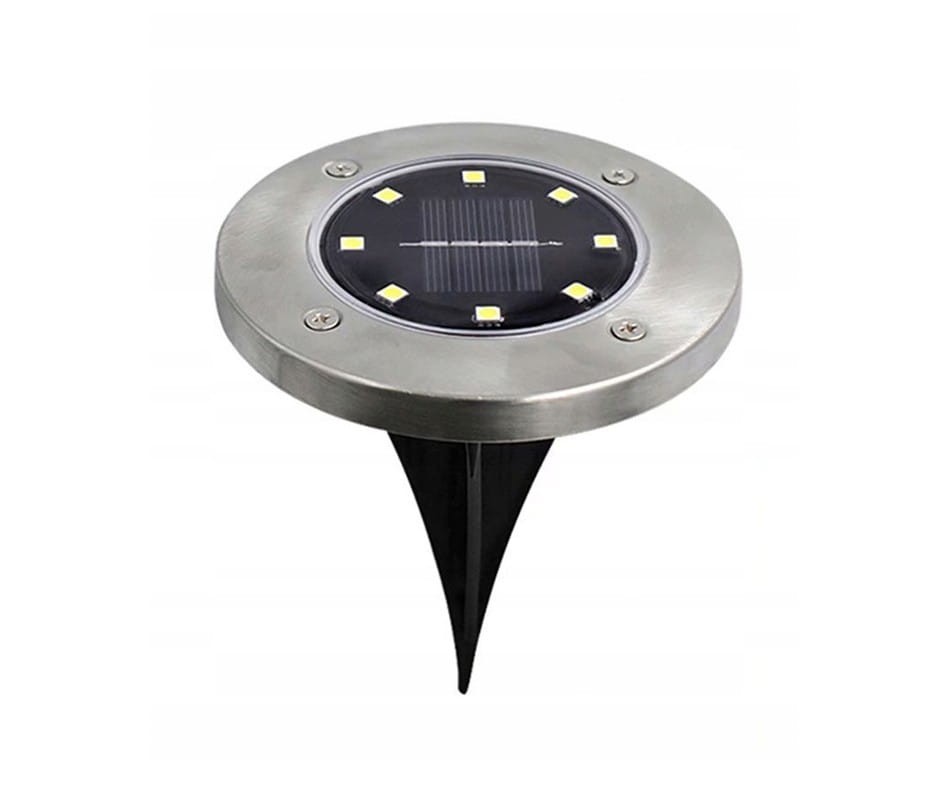 Srebrna lampa solarna ogrodowa Terra, wbijana w ziemię, z okrągłą podstawą i sześcioma diodami LED. Produkt widoczny z góry, z czarnym panelem słonecznym w centrum. Idealna do oświetlenia przestrzeni zewnętrznych.
