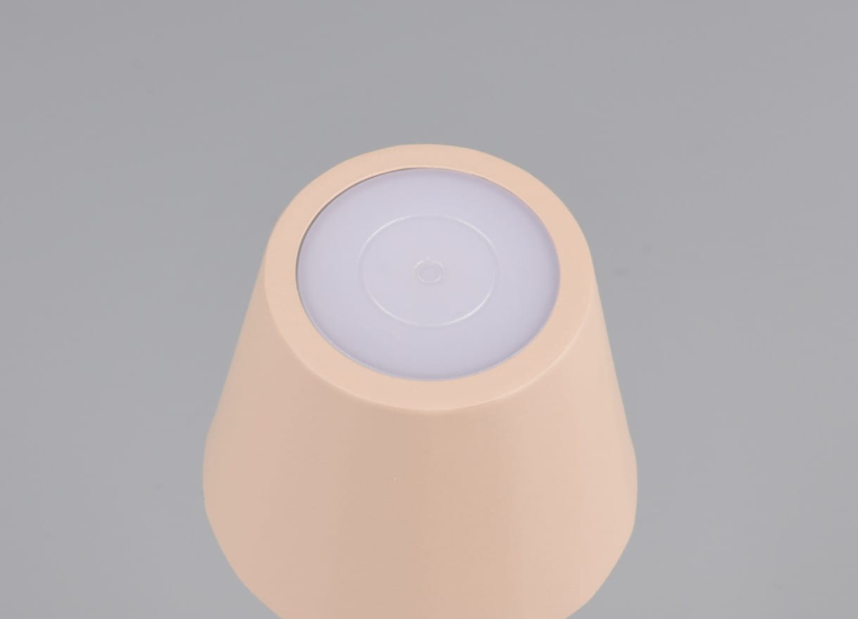 Lampa stołowa zewnętrzna Diaz w kolorze piaskowym, z okrągłym, białym kloszem LED na górze. Produkt widoczny z góry, z zaokrąglonym kształtem i matową powierzchnią. Idealna do oświetlenia przestrzeni na świeżym powietrzu.