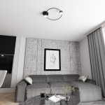 Lampa sufitowa Lucio 2xGX53 w kolorze czarnym, o okrągłym kształcie, zamontowana na suficie. Posiada dwa źródła światła umieszczone na końcach ramy. Tło to nowoczesny salon z szaro-skalnym wykończeniem i minimalistycznymi meblami.