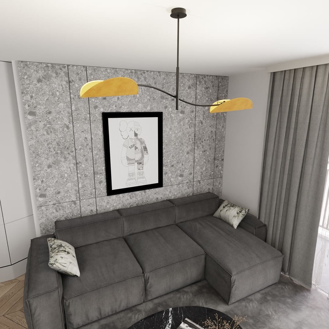 Lampa sufitowa Lotus w kolorze czarnym i pomarańczowym z dwoma kloszami E14, zamontowana na cienkim metalowym ramieniu. Ujęcie z góry, w nowoczesnym wnętrzu z szarymi ścianami i ciemnoszarym narożnikiem.