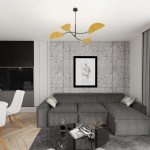 Czarna lampa sufitowa Lotus z czterema oprawami E14, ozdobiona pomarańczowymi, stylizowanymi elementami. Zawieszona w nowoczesnym wnętrzu, na tle szarej ściany z grafiką, nad szarym sofą i okrągłym, czarnym stołem.