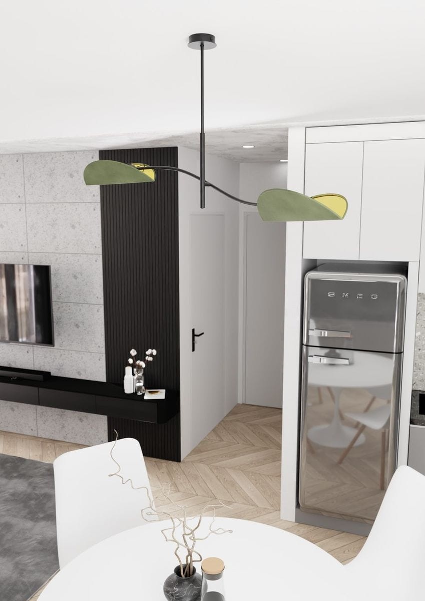 Lampa sufitowa Lotus 2xE14 w kolorze czarnym i zielonym, z dwoma asymetrycznymi kloszami. Zawieszona na cienkim, czarnym przewodzie, w nowoczesnym wnętrzu z białymi meblami i drewnianą podłogą. Idealna do aranżacji kuchni lub jadalni.