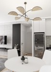 Czarna lampa sufitowa Lotus z sześcioma kloszami E14 w naturalnym kolorze, umieszczona w kuchni. Klosze mają kształt liści, a całość jest zawieszona na cienkim metalowym ramieniu.