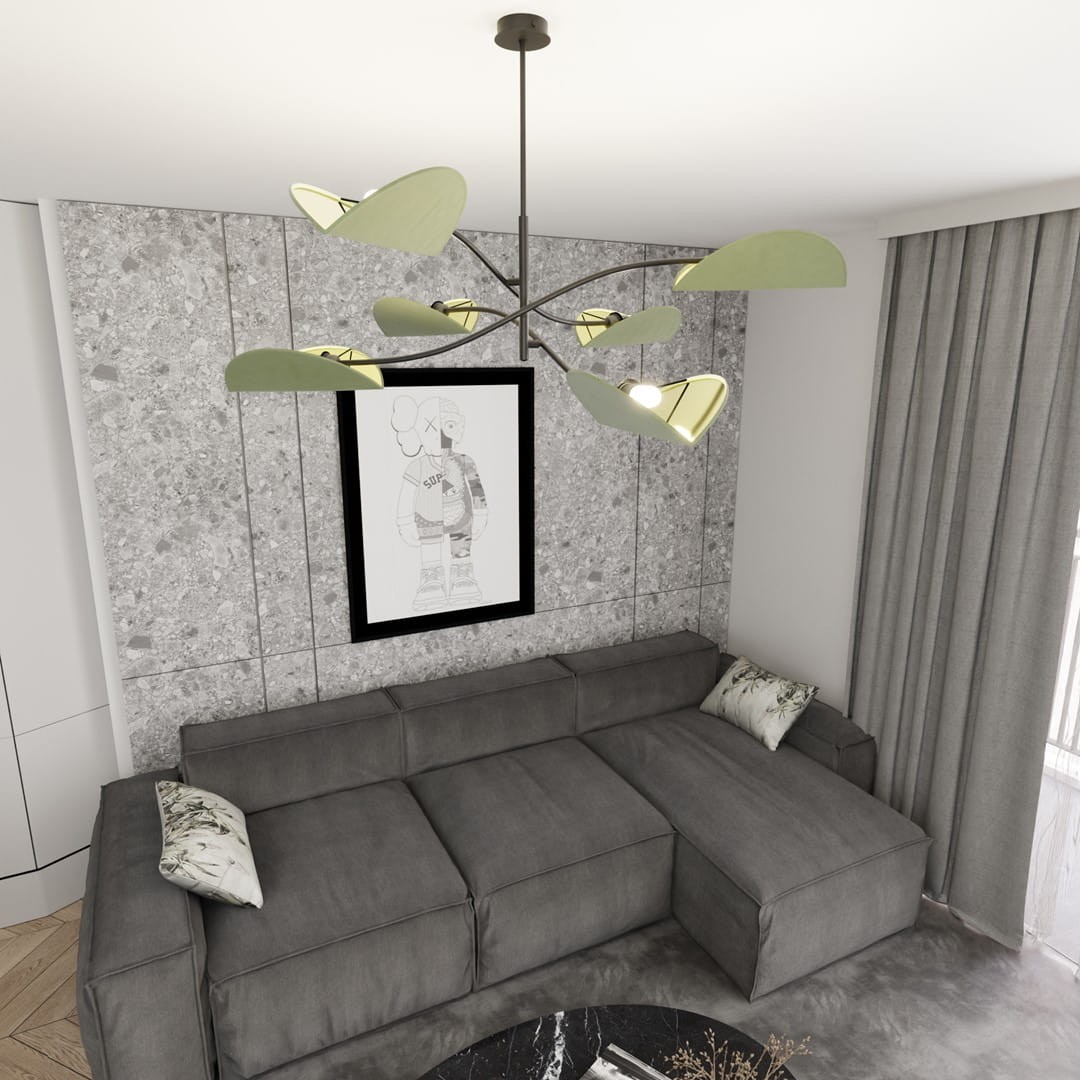 Czarna lampa sufitowa Lotus z sześcioma źródłami światła E14, z zielonymi, liściastymi kloszami. Zawieszona na cienkim, metalowym stelażu w nowoczesnym stylu, umiejscowiona w jasnym wnętrzu z szarym narożnikiem i dekoracyjnym obrazem na ścianie.