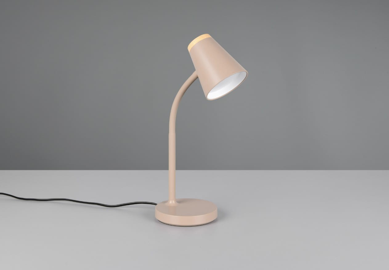 Beżowa lampa biurkowa Pongo z jedną żarówką LED 4,5W. Ujęcie z boku, stojąca na okrągłej podstawie. Smukły, zakrzywiony kształt ramienia oraz stożkowy klosz z białym wnętrzem i drewnianym akcentem na górze. Kabel zasilający widoczny obok.