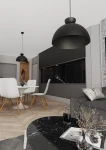 Czarna lampa wisząca Lunaro L z jednym źródłem światła GX53, w stylowym, zaokrąglonym kształcie. Zawieszona nad okrągłym stołem w jadalni, na tle ciemnych szafek kuchennych i jasnych krzeseł. Eleganckie, nowoczesne wykończenie.
