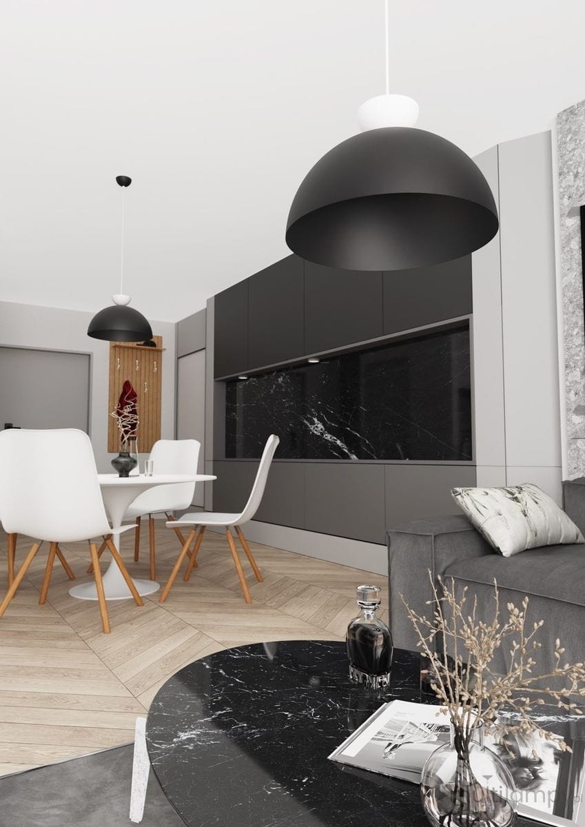 Lampa wisząca Lunaro L z jednym źródłem światła GX53 w kolorze czarnym i białym. Zawieszona nad okrągłym stołem w nowoczesnej kuchni, w tle szafki kuchenne w odcieniach szarości i czarnym marmurze.