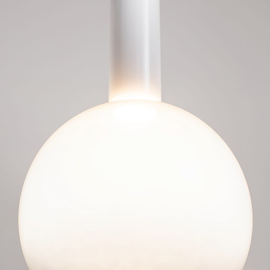 Lampa wisząca Nebula D25 w kolorze białym, z kulistym kloszem z matowego szkła. Posiada pojedynczy moduł LED o mocy 6W. Ujęcie zbliżeniowe na górną część lampy, ukazujące detal mocowania. Tło w neutralnym odcieniu.