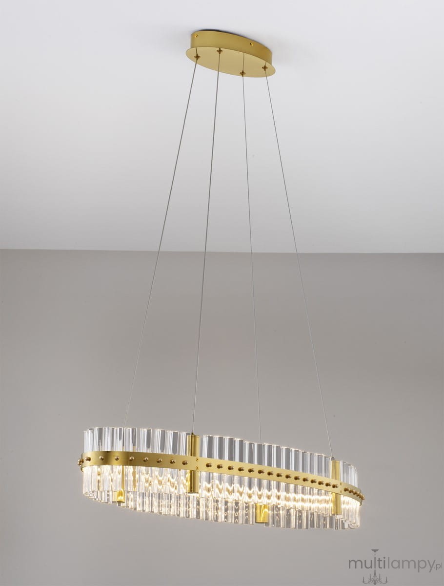 Lampa wisząca Mayo D90 w kolorze złotym z jedną diodą LED o mocy 45W. Okrągła, z przezroczystymi elementami, zawieszona na cienkich linkach. Wisi pod sufitem, na jednolitym tle.